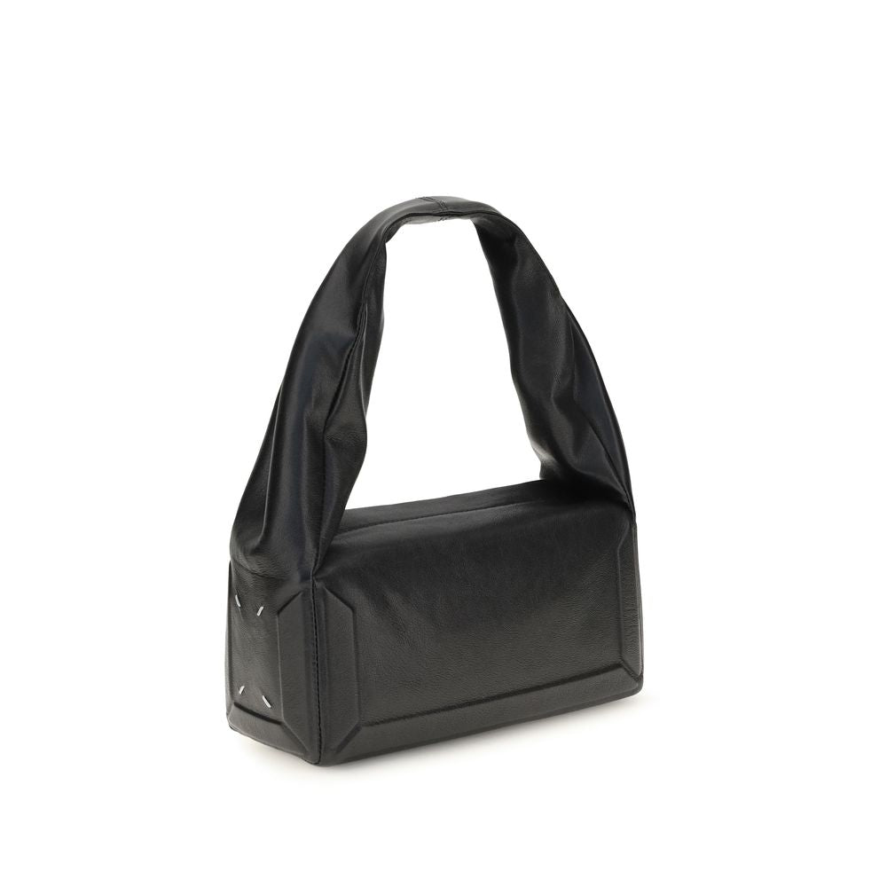 Maison Margiela black leather handbag with sleek design and minimalist accents, showcasing the elegant accessory.