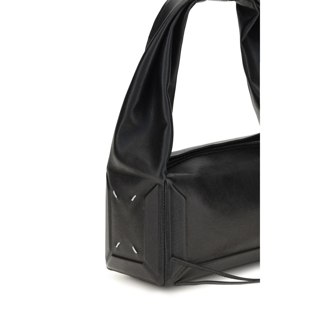 Maison Margiela black leather handbag with structured design and subtle branding, featuring top handles and sleek finish.