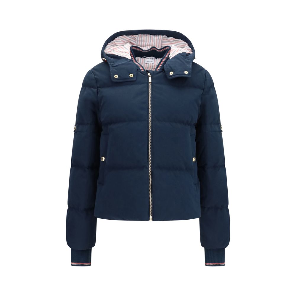 Thom Browne blue cotton full-length jacket displayed on a hanger with detailed stitching and classic tailored design.