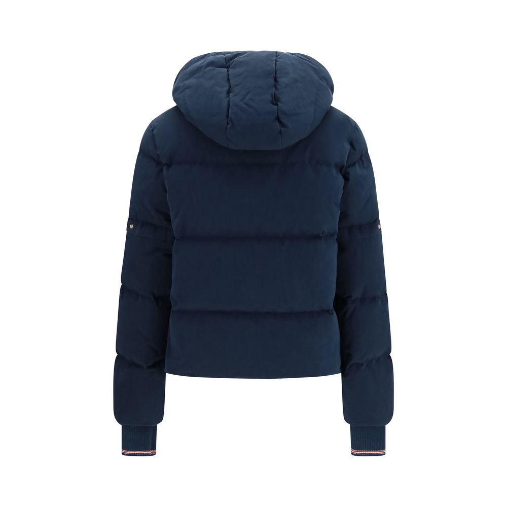 Thom Browne blue cotton full-length jacket displayed on a hanger, showcasing tailored design and classic style.