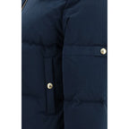 Thom Browne blue cotton full-length jacket displayed on a hanger, showcasing its tailored design and classic style.