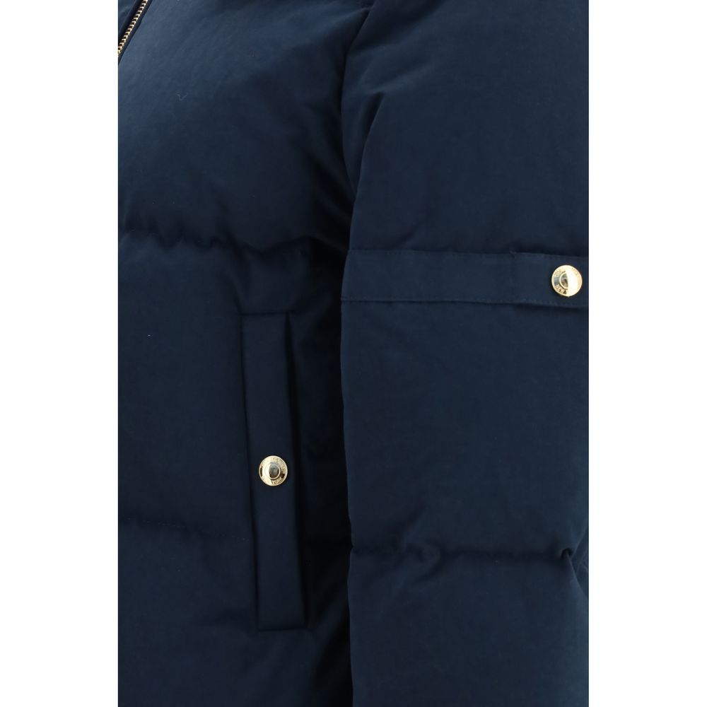 Thom Browne blue cotton full-length jacket displayed on a hanger, showcasing its tailored design and classic style.