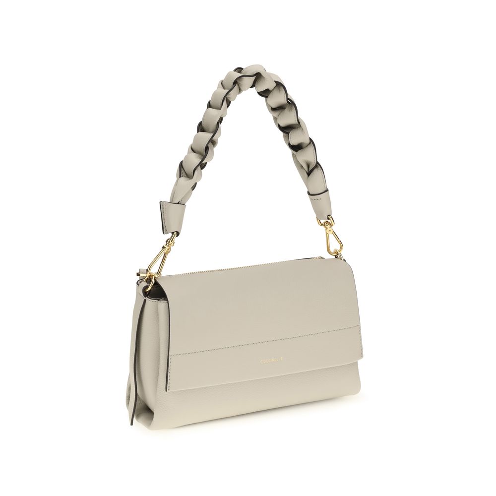 Coccinelle beige calf leather Bos Taurus shoulder bag with top handle and silver hardware, stylish and spacious for daily use.