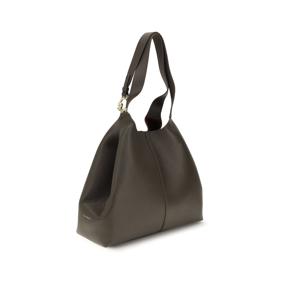 Coccinelle brown calf leather Bos Taurus shoulder bag with silver hardware and structured design, featuring top handles and a spacious interior.