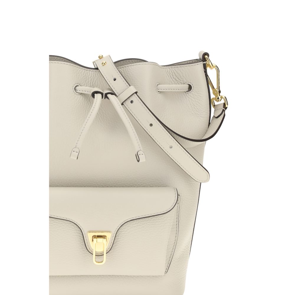 Beige calf leather Coccinelle Bos Taurus backpack bag with silver hardware and adjustable straps.