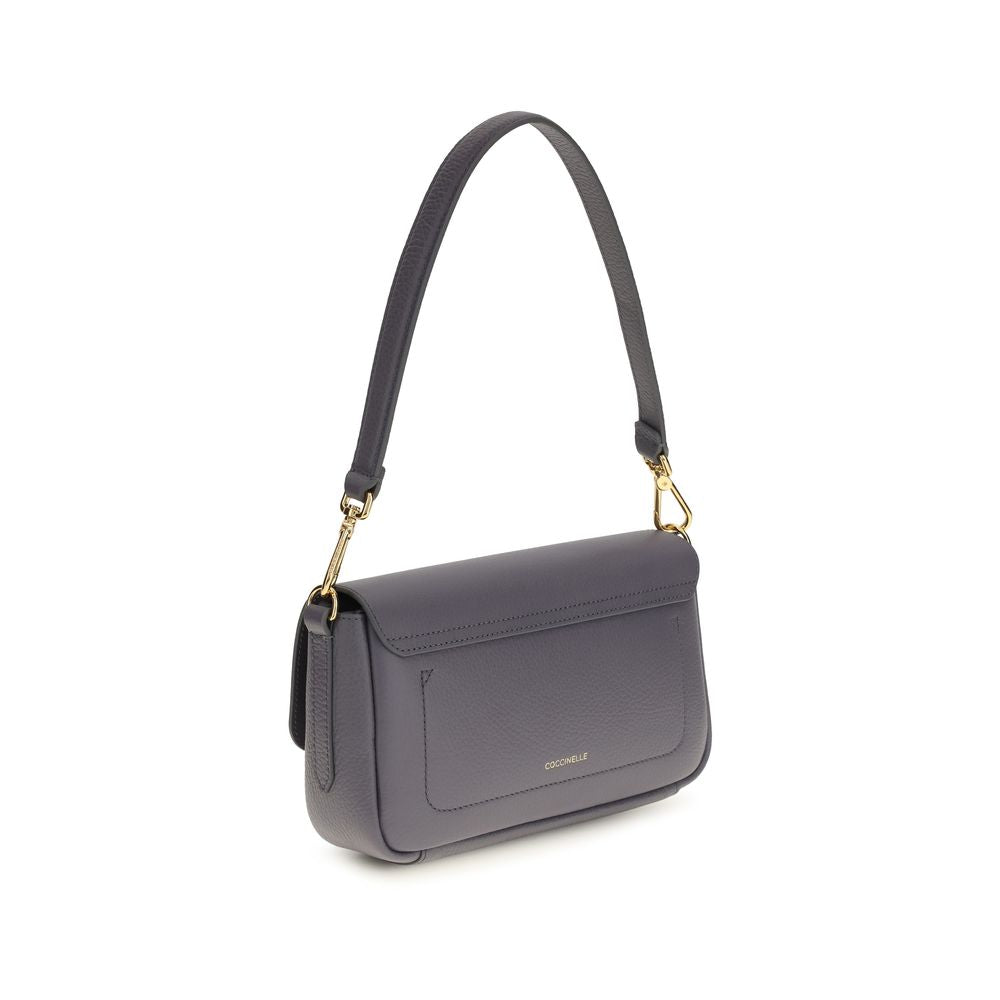 Blue calf leather Coccinelle Bos Taurus shoulder bag with silver hardware and structured design, showcasing a stylish and elegant accessory.