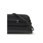 Black Moschino goatskin clutch bag with sleek design and gold-tone hardware, perfect for elegant evening accessories.