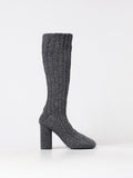 Gray Bottega Veneta wool over-the-knee boots displayed on a model standing on a city street.