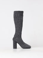 Gray Bottega Veneta wool over-the-knee boots displayed on a model standing on a city street.