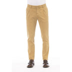 Beige cotton men's pants by Peserico, tailored fit with classic design, shown on a model with side pockets and belt loops.