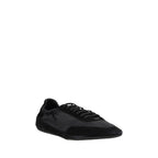 Prada black calf leather Bos Taurus athletic sneakers with sleek design and lace-up closure.