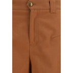 Chloé orange cotton casual pants with a relaxed fit and waistband, displayed on a hanger against a neutral background.
