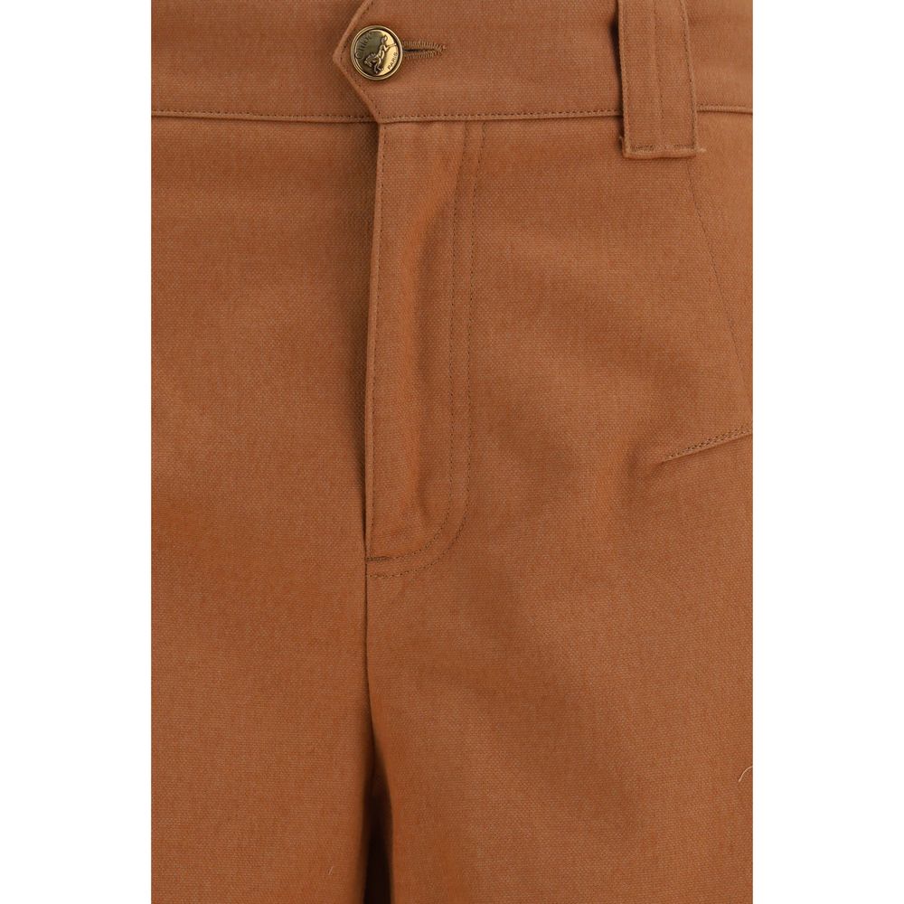 Chloé orange cotton casual pants with a relaxed fit and waistband, displayed on a hanger against a neutral background.