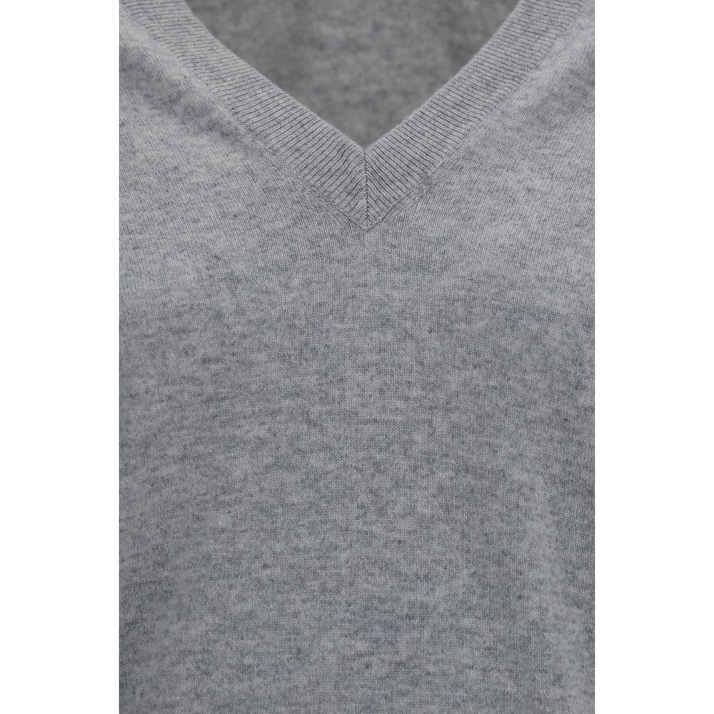 Brunello Cucinelli gray cashmere sweater displayed on a hanger, showcasing soft knit fabric and classic crewneck style.