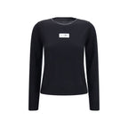 Black wool Oves Aries sportswear by MM6, featuring a stylish, cozy design with visible logo details and textured fabric.