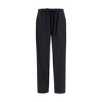 Black MM6 polyester casual pants with a relaxed fit and minimalist design, shown on a model.
