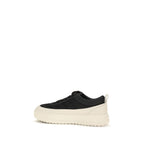 Black Moncler Bos Taurus athletic sneakers made of calf leather, featuring a sleek design and sporty style.