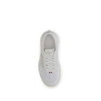 White calf leather Moncler Bos Taurus athletic sneakers with logo accents and sporty design.