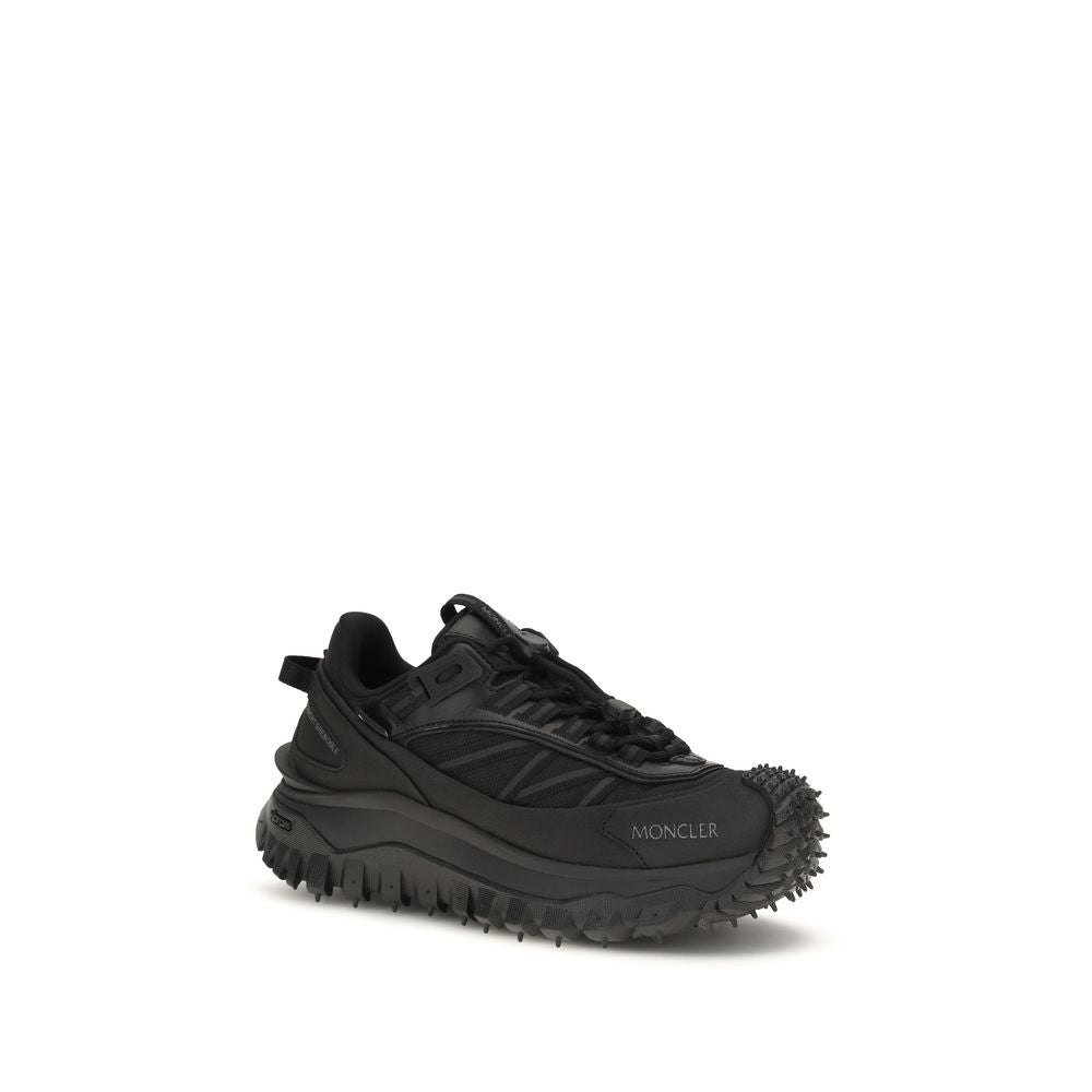 Black calf leather Moncler Bos Taurus athletic sneakers with sleek design and sporty laces on a clean background.