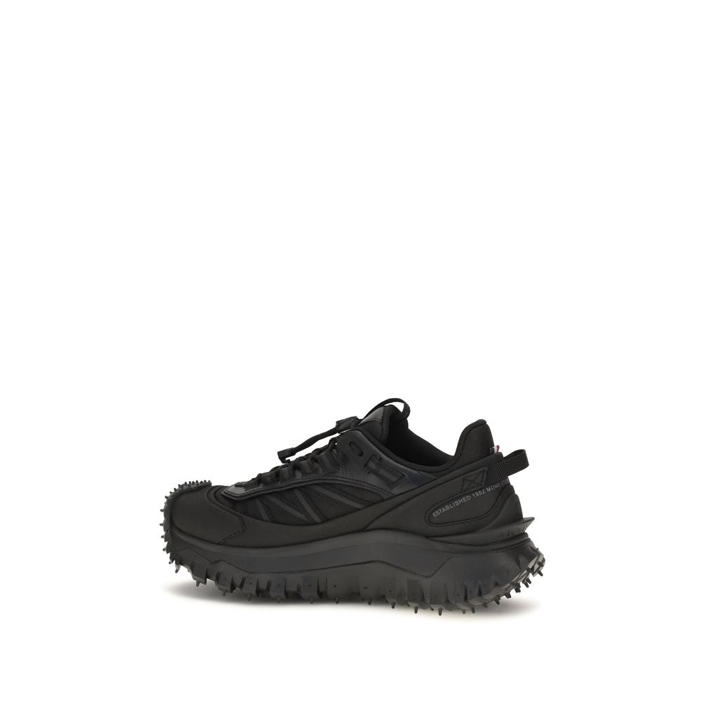 Black calf leather Moncler Bos Taurus athletic sneakers with sleek design and sporty style.