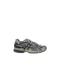 Silver polyester athletic sneakers by New Balance with white soles and sporty design, perfect for running and active wear.