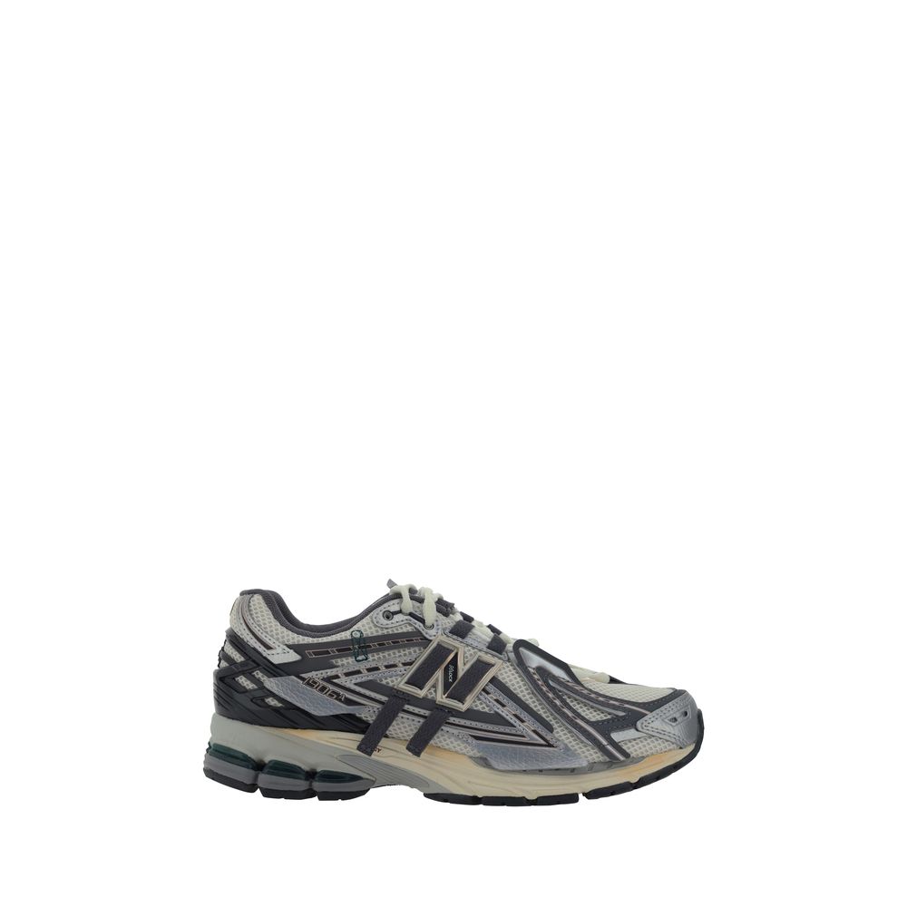 Silver polyester athletic sneakers by New Balance with white soles and sporty design, perfect for running and active wear.