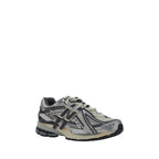 Silver polyester athletic sneakers by New Balance featuring sleek design and supportive sole for active wear.