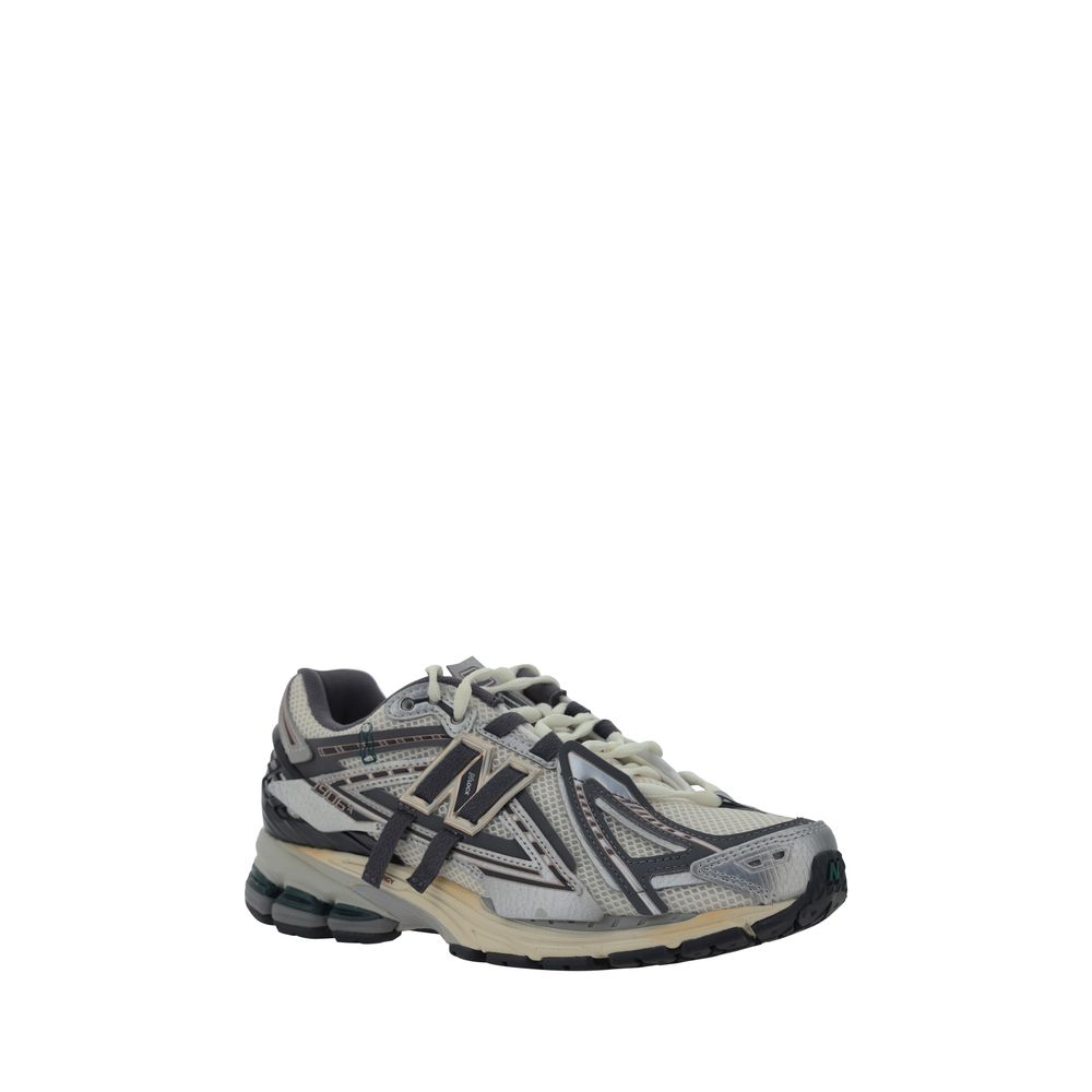 Silver polyester athletic sneakers by New Balance featuring sleek design and supportive sole for active wear.