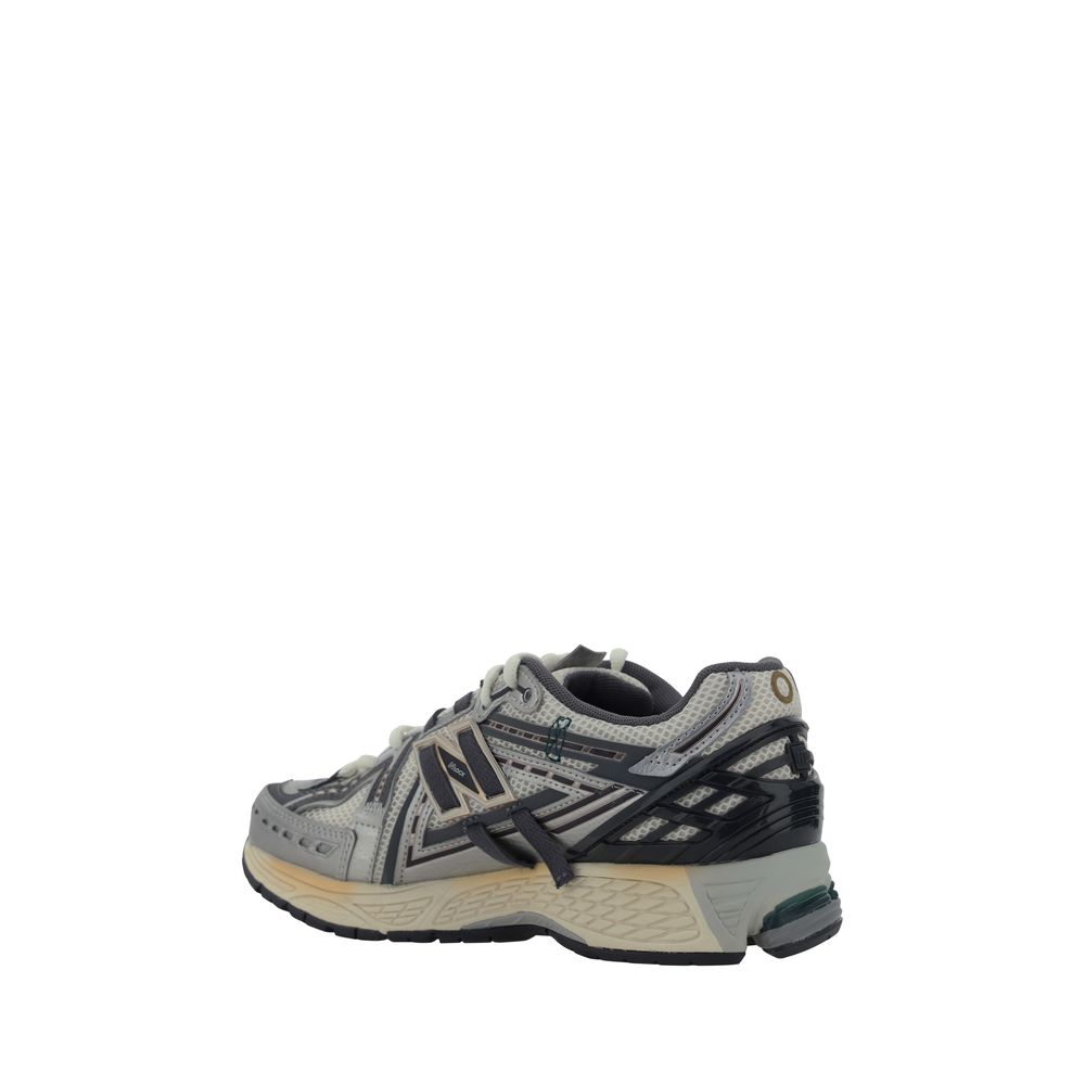 New Balance silver polyester athletic sneakers with sleek design and cushioned soles for active wear.