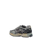 New Balance silver polyester athletic sneakers with sleek design and cushioned soles for active wear.