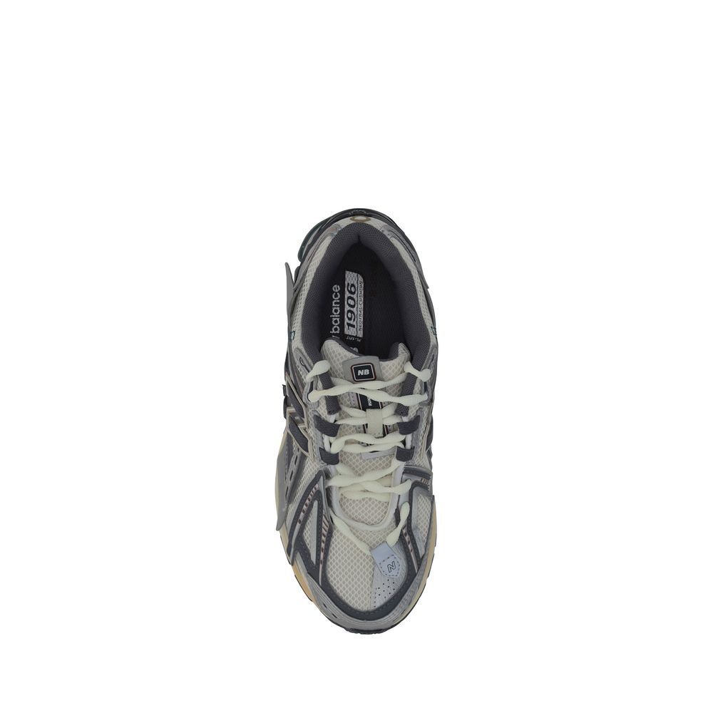 New Balance silver polyester athletic sneakers with white soles and streamlined design for running and active wear.