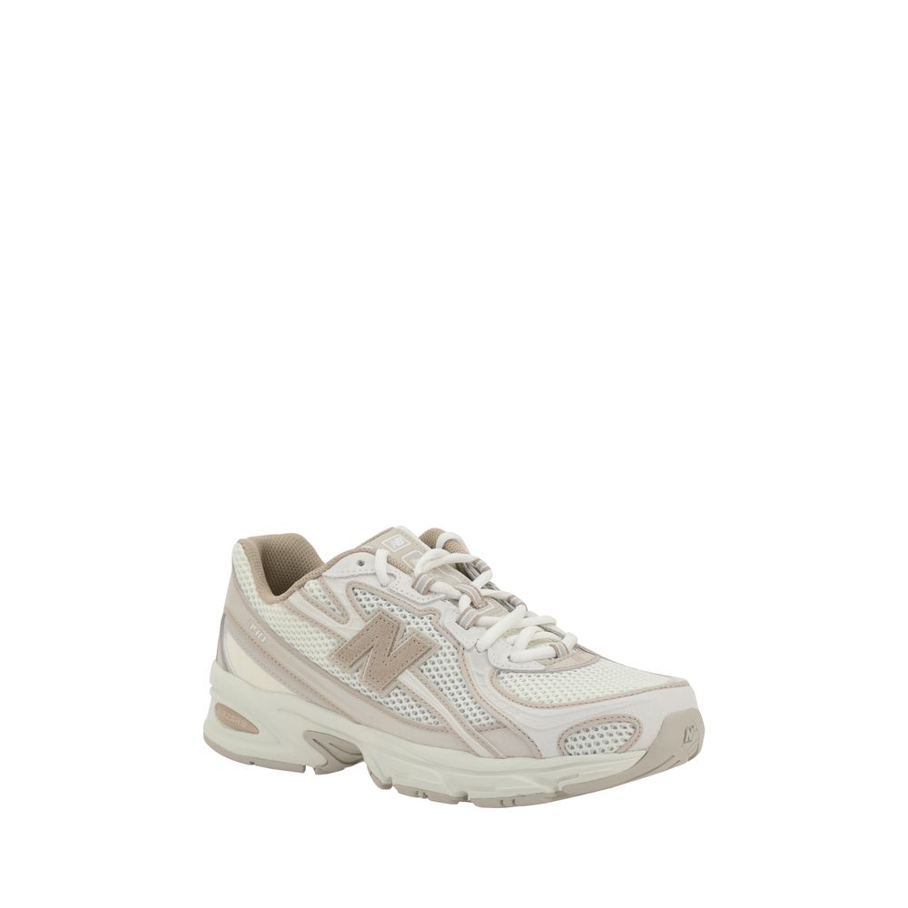White nylon athletic sneakers by New Balance with a sleek design and cushioned sole for comfortable sportswear.