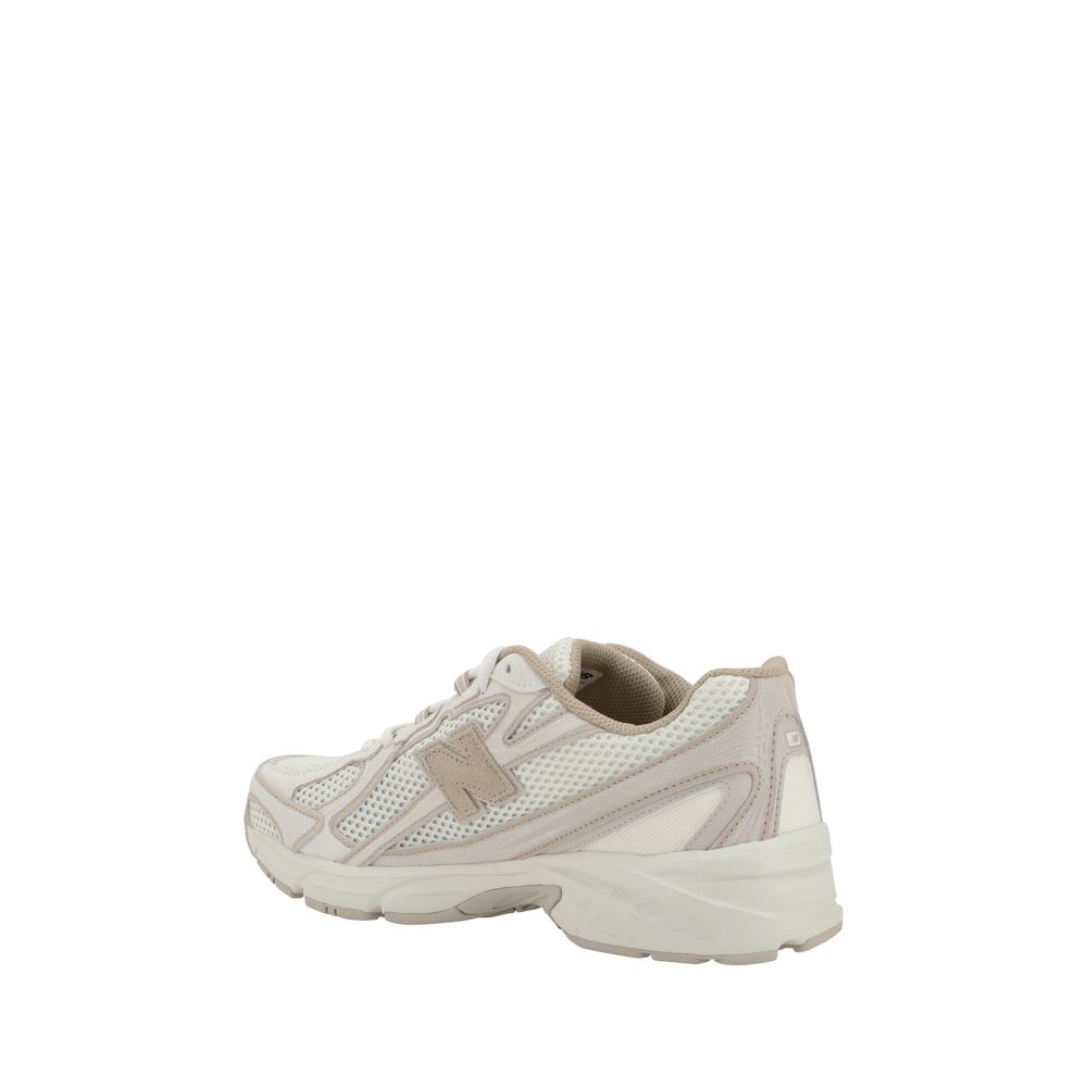 White nylon athletic sneakers by New Balance with a sleek design and cushioned soles for comfort and performance.