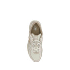 White nylon New Balance athletic sneakers with laces and rubber soles, designed for sports and casual wear.