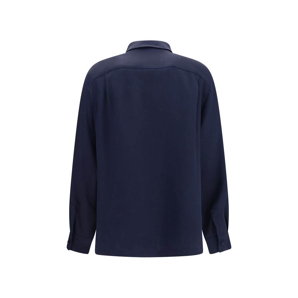 Max Mara blue silk shirt displayed on a hanger, featuring a classic collar and smooth, luxurious fabric.
