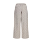 Beige Off-White cotton casual pants with relaxed fit and signature branding, displayed on a hanger.
