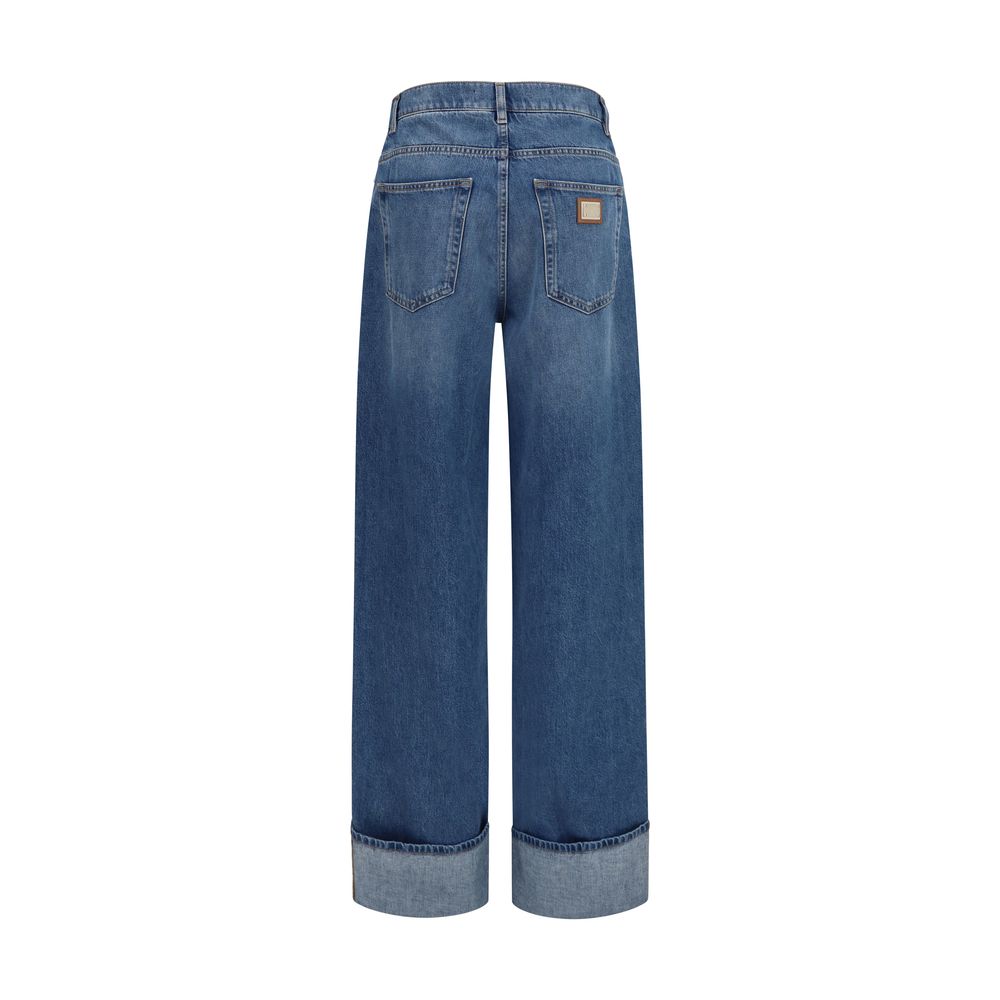 Dolce & Gabbana blue cotton straight-leg jeans displayed on a clothing rack with visible stitching and classic five-pocket design.