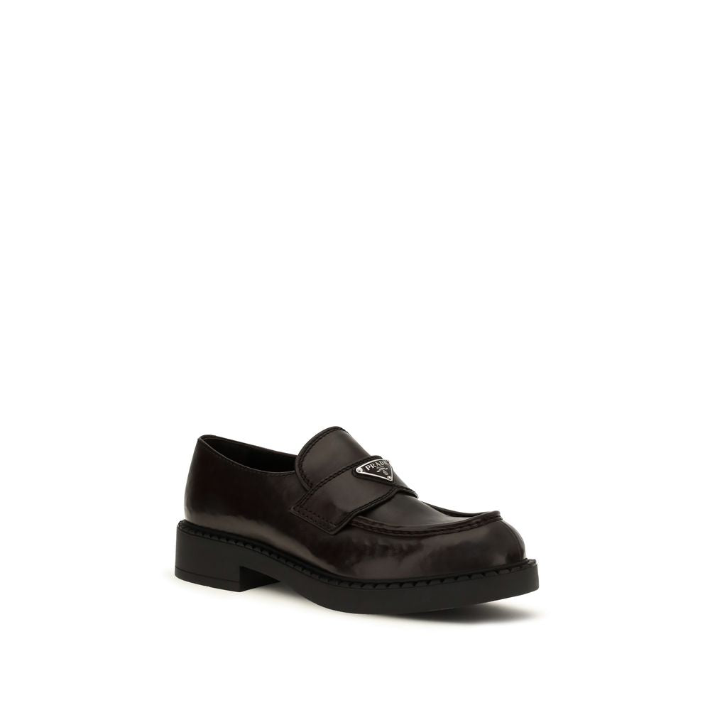 Prada brown calf leather Bos Taurus slip-on loafers with sleek design and classic style, featuring smooth leather finish.