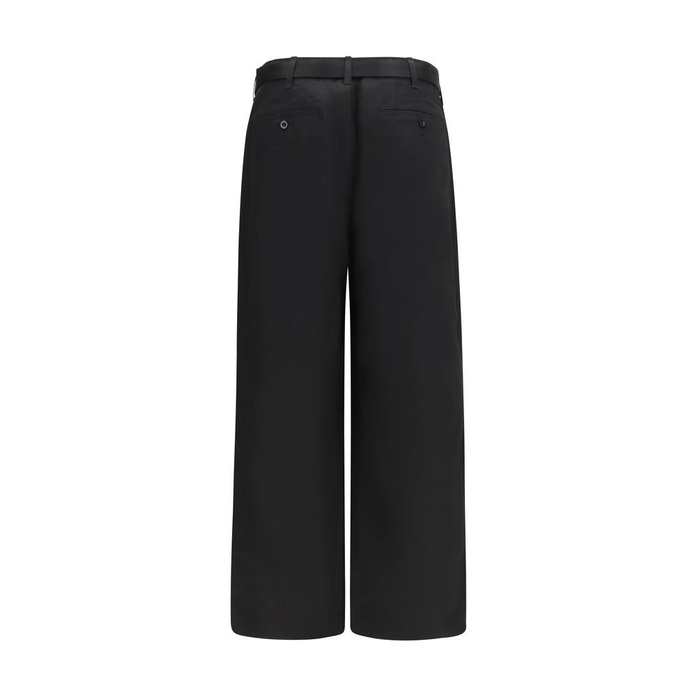 Sacai black cotton chino pants with tailored fit and classic design, shown on a neutral background.