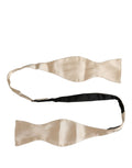 Beige Dolce & Gabbana men's silk adjustable bow tie with papillon style, showcasing elegant craftsmanship and classic design.