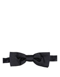 Dark blue Dolce & Gabbana men's silk adjustable bow tie with papillon style on a clean background.