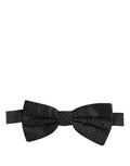 Dolce & Gabbana dark blue and white polka dot adjustable neck papillon bow tie on a mannequin.