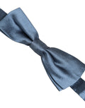 Light blue silk adjustable bow tie by Dolce & Gabbana with a classic papillon style, shown hanging on a display.