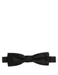 Dark gray Dolce & Gabbana silk bow tie with adjustable neck strap, elegant men's accessory for formal wear.