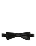 Black floral silk bow tie with adjustable neck strap from Dolce & Gabbana, stylish men's accessory for formal occasions.