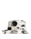 Dolce & Gabbana white cotton bucket hat with large black polka dot pattern, stylish sun protection accessory.