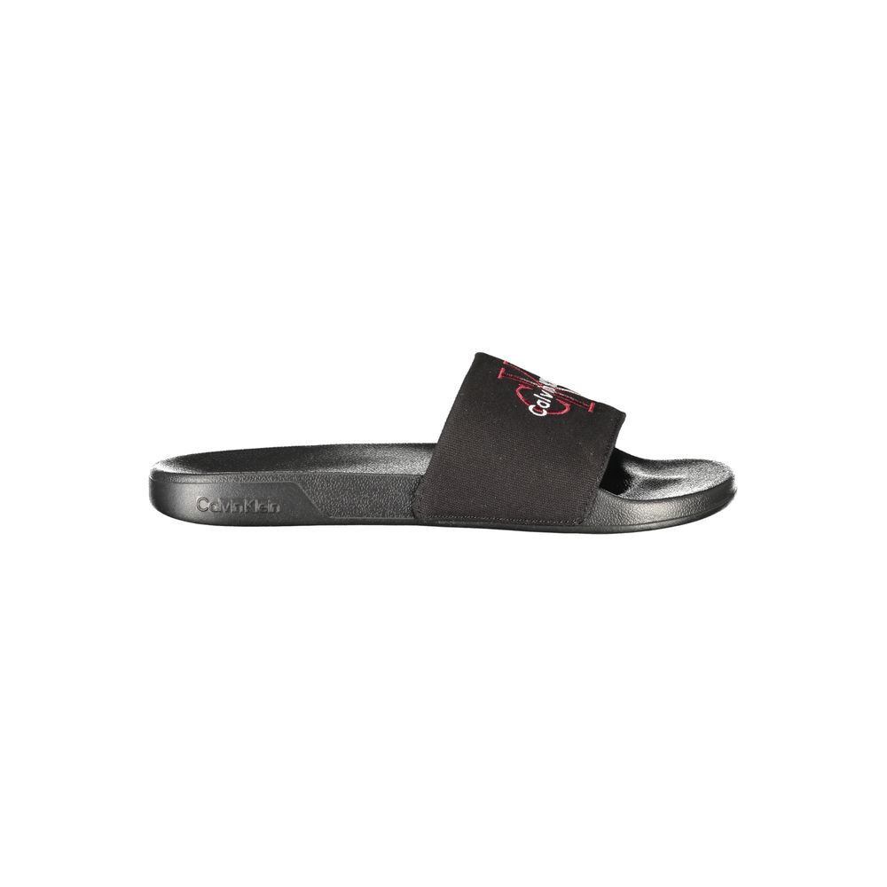 Calvin Klein black polyester men's slipper with cushioned sole and slip-on design, ideal for comfortable indoor wear.