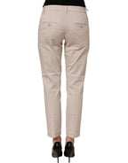 Dondup beige low waist tapered women cropped trousers shown on a model, featuring a relaxed fit and stylish design.
