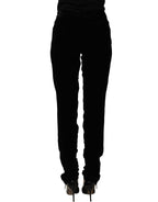 Black Ermanno Scervino velvet slim fit pants made of viscose blend, shown hanging on a clothing rack.