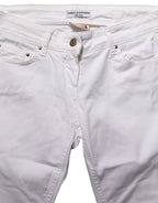 White cotton stretch skinny denim jeans by Daniele Alessandrini, showing close-up of fitted waist and classic five-pocket design.